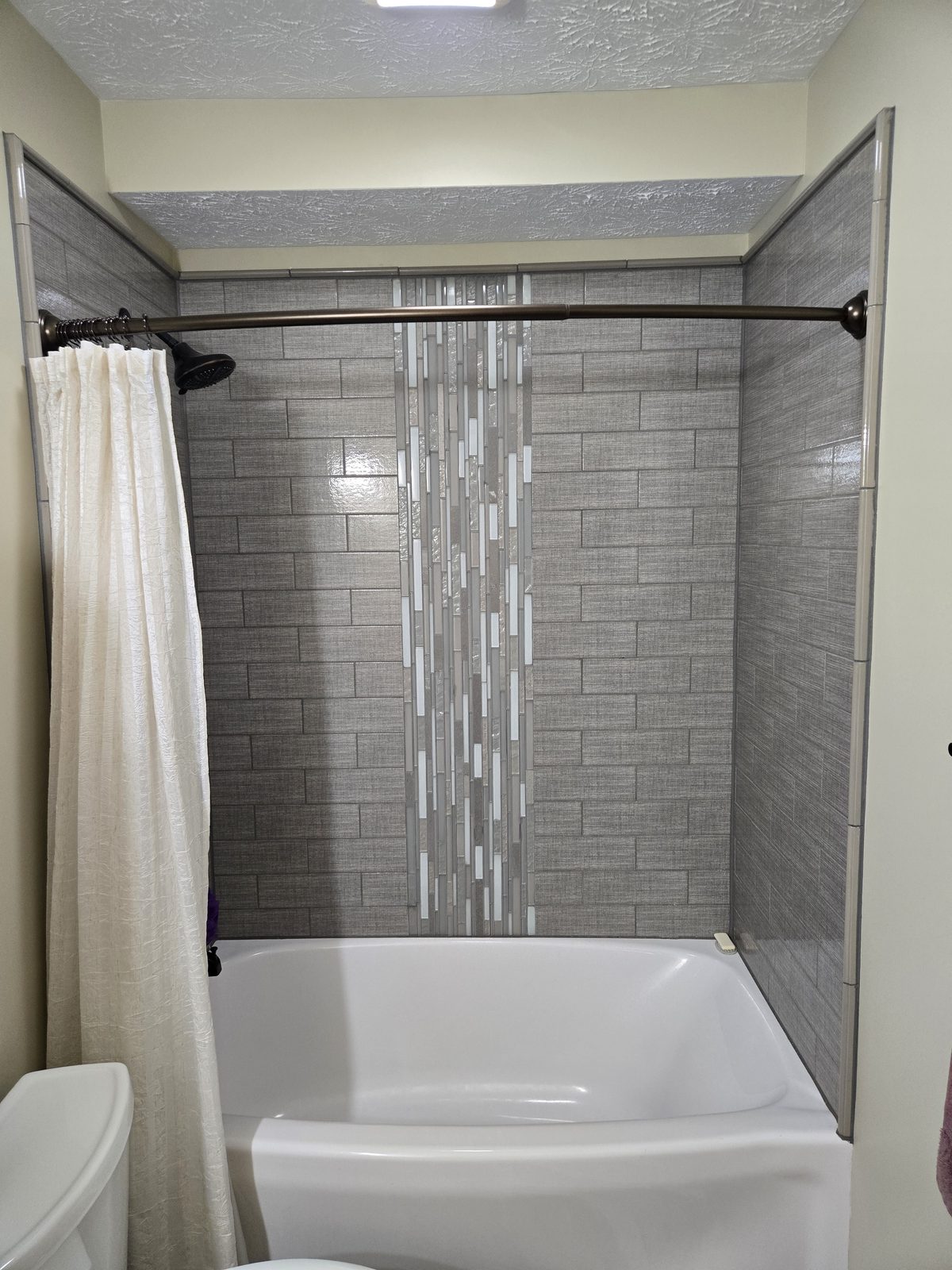 Tub and shower with tile accent band