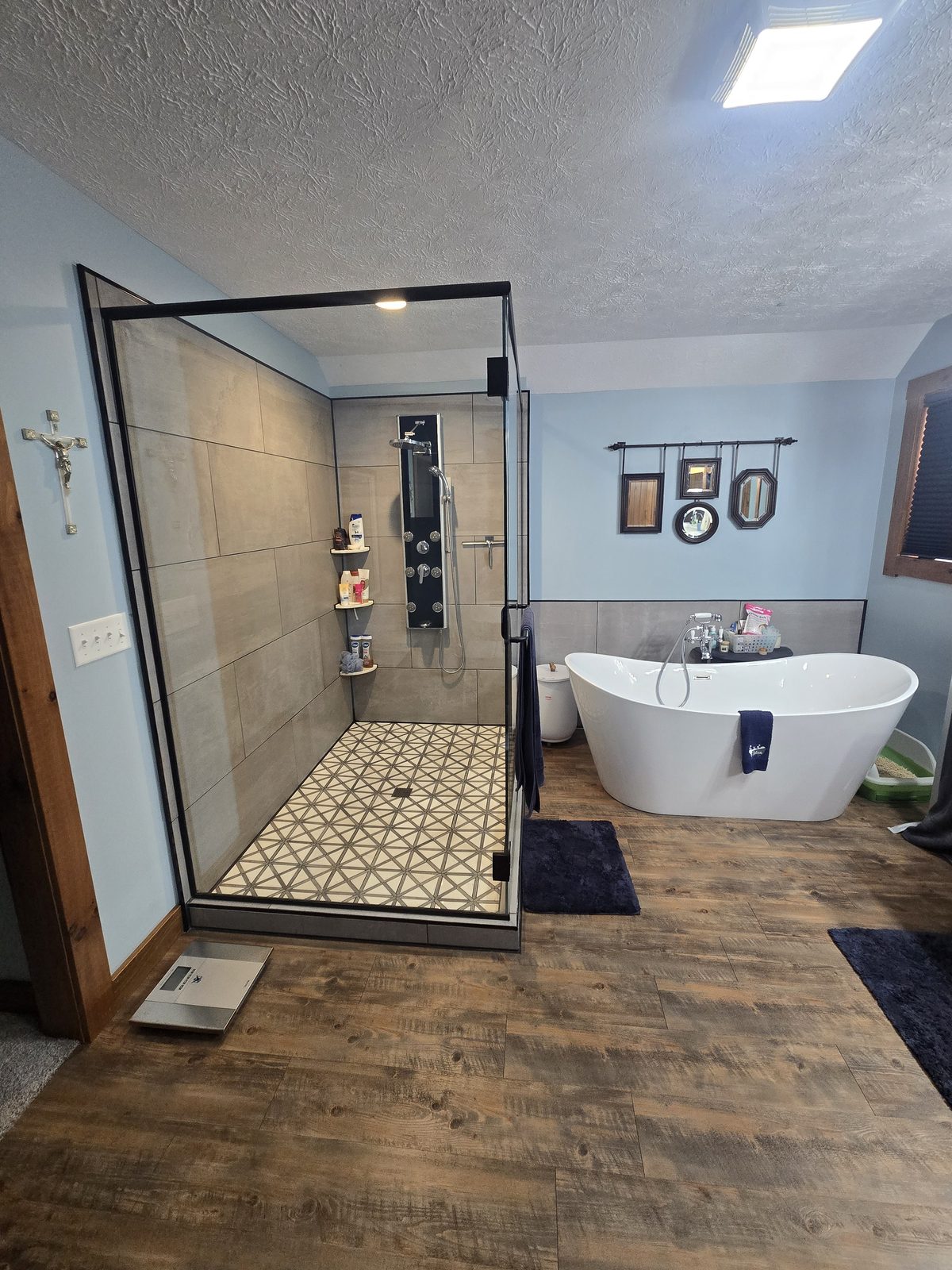 Finished master bathroom with glass shower and freestanding tub