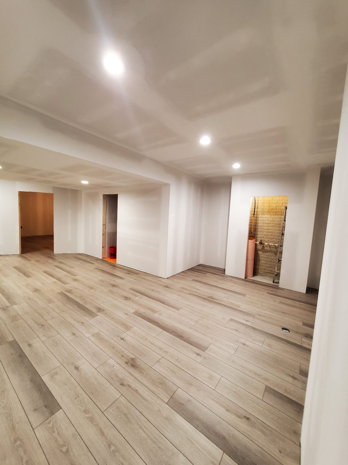 Open finished basement with luxury vinyl plank flooring