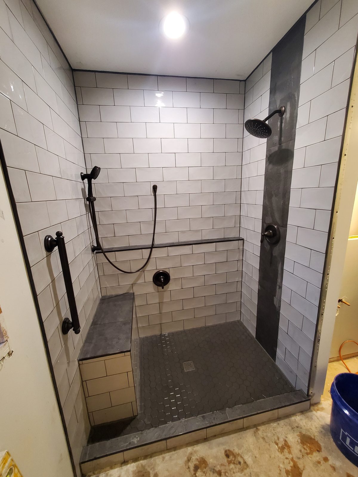 Curbless walk-in shower with black fixtures