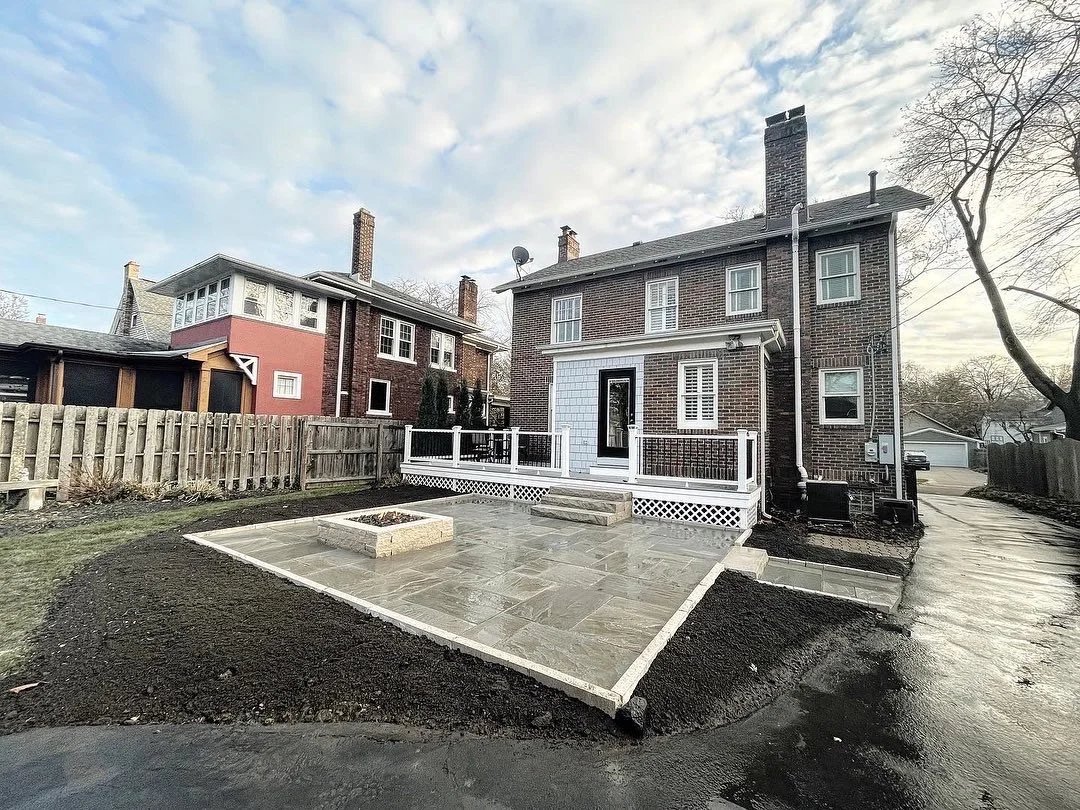 Bluestone patio with a raised stone fire pit and deck
