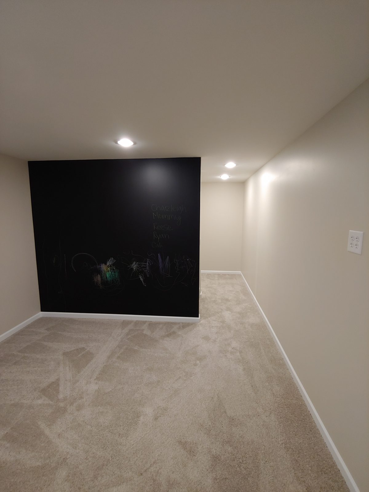 Finished basement rec room with accent wall